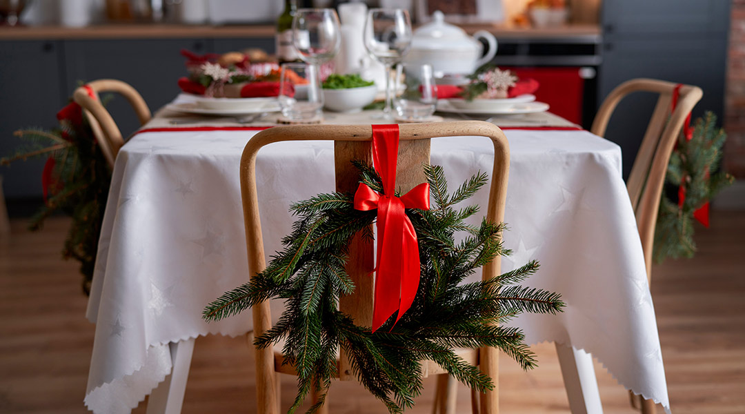 Decoración de sillas con lazos y detalles navideños